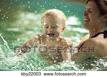 Stock Photo - mother splashing 
with baby son 
in swimming pool. 
fotosearch - search 
stock photos, 
pictures, images, 
and photo clipart