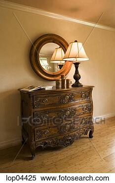 Stock Image - ornate wood dresser 
with lamp and 
round mirror. 
fotosearch - search 
stock photos, 
pictures, images, 
and photo clipart