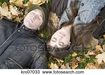 Stock Photo - overhead view 
of couple lying 
in autumn leaves. 
fotosearch - search 
stock photos, 
pictures, images, 
and photo clipart