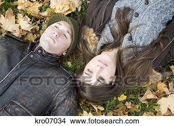Stock Photo - overhead view 
of couple lying 
in autumn leaves. 
fotosearch - search 
stock photos, 
pictures, images, 
and photo clipart
