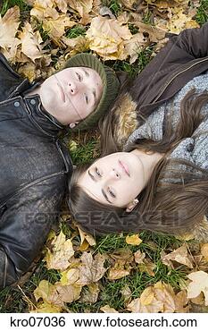 Stock Photo - overhead view 
of couple lying 
in autumn leaves. 
fotosearch - search 
stock photos, 
pictures, images, 
and photo clipart