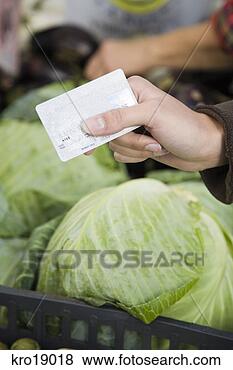 Stock Photo - person holding 
credit card over 
vegetables. fotosearch 
- search stock 
photos, pictures, 
images, and photo 
clipart