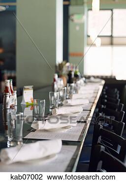 Stock Photo - place settings 
and stools at 
bar. fotosearch 
- search stock 
photos, pictures, 
images, and photo 
clipart