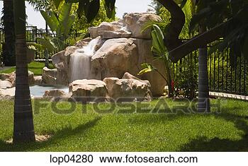 Stock Photography - rock formation 
with waterfall 
in backyard. fotosearch 
- search stock 
photos, pictures, 
images, and photo 
clipart