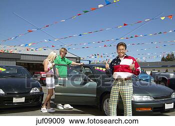 Stock Photograph - salesman selling 
car to couple. 
fotosearch - search 
stock photos, 
pictures, images, 
and photo clipart