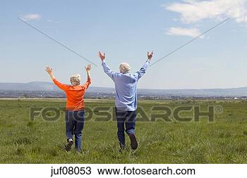 Stock Photo - senior couple 
running through 
fields. fotosearch 
- search stock 
photos, pictures, 
images, and photo 
clipart
