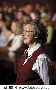 Stock Photo - senior female 
theatre usher 
laughing. fotosearch 
- search stock 
photos, pictures, 
images, and photo 
clipart
