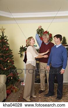 Stock Photo - senior man holding 
mistletoe for 
husband and wife. 
fotosearch - search 
stock photos, 
pictures, images, 
and photo clipart