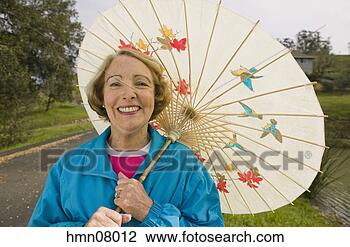 Stock Photo - senior woman using 
parasol. fotosearch 
- search stock 
photos, pictures, 
images, and photo 
clipart