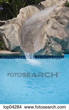 Stock Photo - slide to pool 
cut out of rocks. 
fotosearch - search 
stock photos, 
pictures, images, 
and photo clipart
