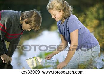 Stock Photograph - students examining 
plants in lake. 
fotosearch - search 
stock photos, 
pictures, images, 
and photo clipart