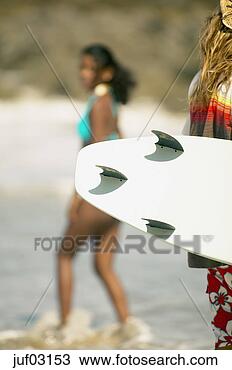 Stock Photo - surfer holding 
surfboard on beach. 
fotosearch - search 
stock photos, 
pictures, images, 
and photo clipart