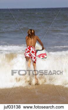 Stock Photo - surfer jumping 
into ocean waves. 
fotosearch - search 
stock photos, 
pictures, images, 
and photo clipart