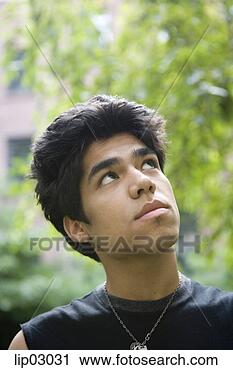 Stock Photography - teenage boy looking 
up. fotosearch 
- search stock 
photos, pictures, 
images, and photo 
clipart