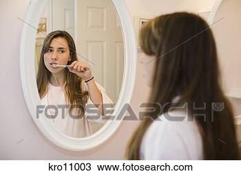 Stock Photo - teenage girl brushing 
her teeth. fotosearch 
- search stock 
photos, pictures, 
images, and photo 
clipart