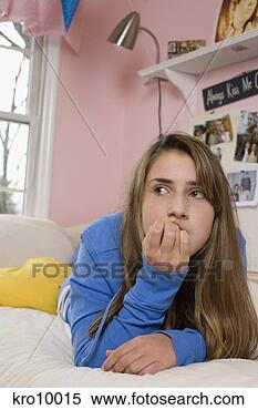 Stock Image - teenage girl laying 
on bed. fotosearch 
- search stock 
photos, pictures, 
images, and photo 
clipart