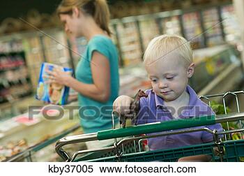 Stock Image - toddler boy playing 
with toy in shopping 
cart. fotosearch 
- search stock 
photos, pictures, 
images, and photo 
clipart