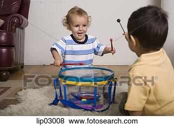 Stock Photo - toddler boys playing 
with drums. fotosearch 
- search stock 
photos, pictures, 
images, and photo 
clipart