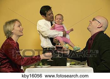 Stock Photo - waiter holding 
crying baby while 
parents toast 
drinks. fotosearch 
- search stock 
photos, pictures, 
images, and photo 
clipart
