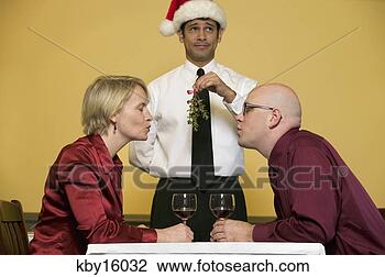 Stock Photo - waiter holding 
mistletoe for 
kissing couple. 
fotosearch - search 
stock photos, 
pictures, images, 
and photo clipart