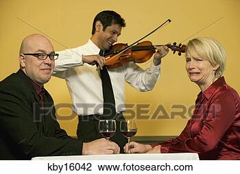 Stock Photo - waiter playing 
romantic music 
for two friends. 
fotosearch - search 
stock photos, 
pictures, images, 
and photo clipart