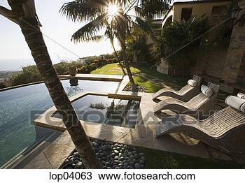 Stock Photo - whicker lounge 
chairs next to 
pool. fotosearch 
- search stock 
photos, pictures, 
images, and photo 
clipart