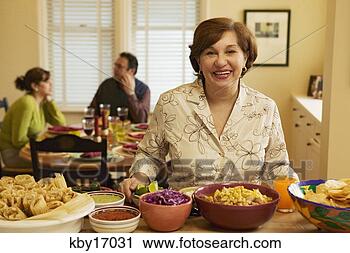 Stock Photography - woman cooking 
dinner. fotosearch 
- search stock 
photos, pictures, 
images, and photo 
clipart