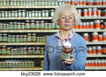 Stock Photo - woman examining 
jar in store. 
fotosearch - search 
stock photos, 
pictures, images, 
and photo clipart