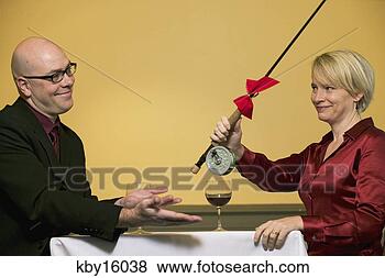Stock Photo - woman giving husband 
present across 
dinner table. 
fotosearch - search 
stock photos, 
pictures, images, 
and photo clipart