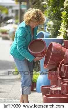 Stock Photography - woman looking 
at clay pots. 
fotosearch - search 
stock photos, 
pictures, images, 
and photo clipart