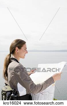 Stock Photo - woman looking 
at map. fotosearch 
- search stock 
photos, pictures, 
images, and photo 
clipart