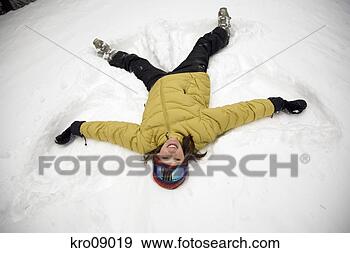 Stock Photograph - woman making a 
snow angel. fotosearch 
- search stock 
photos, pictures, 
images, and photo 
clipart