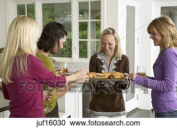 Stock Photography - woman offering 
appetizers to 
friends. fotosearch 
- search stock 
photos, pictures, 
images, and photo 
clipart