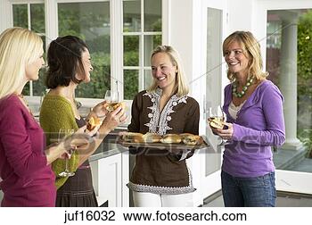 Stock Photo - woman offering 
appetizers to 
friends. fotosearch 
- search stock 
photos, pictures, 
images, and photo 
clipart