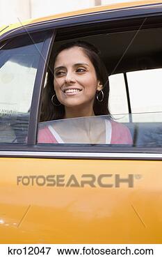 Picture - woman peering 
out of taxi window. 
fotosearch - search 
stock photos, 
pictures, images, 
and photo clipart
