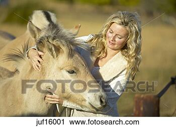 Stock Photography - woman petting 
foal. fotosearch 
- search stock 
photos, pictures, 
images, and photo 
clipart