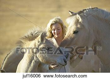 Stock Photo - woman petting 
horse and foal. 
fotosearch - search 
stock photos, 
pictures, images, 
and photo clipart