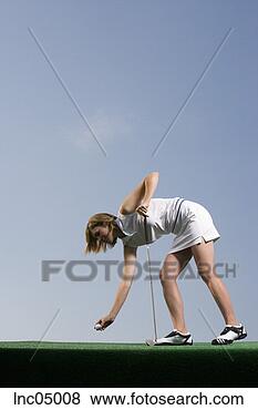 Stock Photo - woman placing 
golf ball on tee. 
fotosearch - search 
stock photos, 
pictures, images, 
and photo clipart