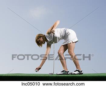 Stock Photography - woman placing 
golf ball on tee. 
fotosearch - search 
stock photos, 
pictures, images, 
and photo clipart