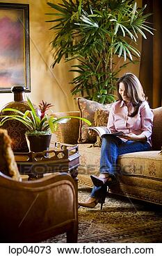 Stock Photo - woman reading 
in comfortable 
living room. fotosearch 
- search stock 
photos, pictures, 
images, and photo 
clipart