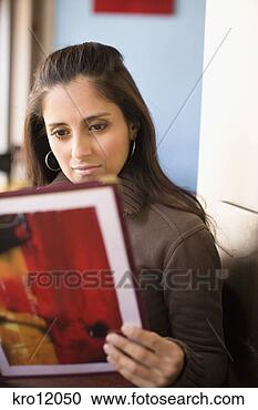 Stock Photography - woman reading 
menu in restaurant. 
fotosearch - search 
stock photos, 
pictures, images, 
and photo clipart