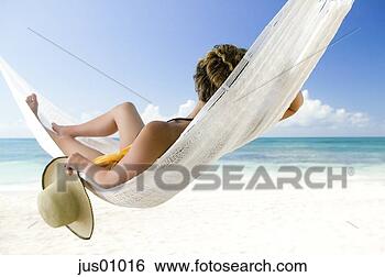Stock Photo - woman relaxing 
in hammock on 
tropical beach. 
fotosearch - search 
stock photos, 
pictures, images, 
and photo clipart