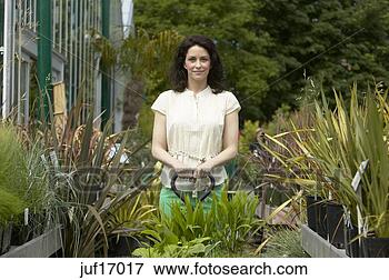 Picture - woman shopping 
at plant nursery. 
fotosearch - search 
stock photos, 
pictures, images, 
and photo clipart