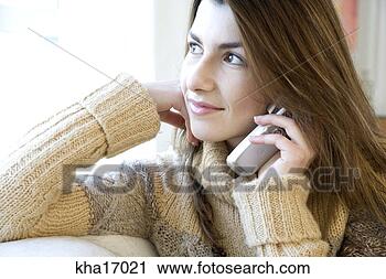 Stock Photography - woman sitting 
on sofa talking 
on cell phone. 
fotosearch - search 
stock photos, 
pictures, images, 
and photo clipart