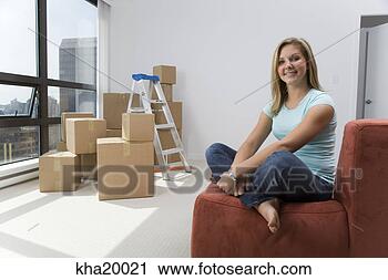 Stock Photography - woman sitting 
on sofa with unpacked 
boxes. fotosearch 
- search stock 
photos, pictures, 
images, and photo 
clipart