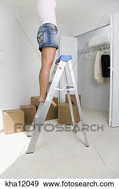 Stock Photograph - woman standing 
on ladder. fotosearch 
- search stock 
photos, pictures, 
images, and photo 
clipart