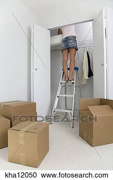 Stock Photography - woman standing 
on ladder in closet. 
fotosearch - search 
stock photos, 
pictures, images, 
and photo clipart