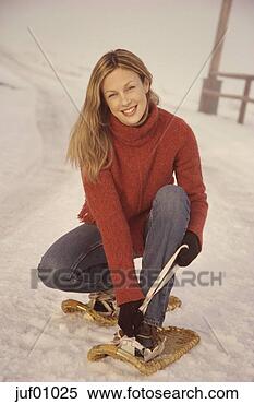 Stock Image - woman tying snowshoes. 
fotosearch - search 
stock photos, 
pictures, images, 
and photo clipart