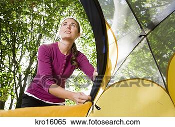 Stock Image - woman zipping 
up tent. fotosearch 
- search stock 
photos, pictures, 
images, and photo 
clipart
