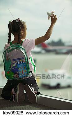 Stock Photo - young african 
girl playing with 
toy airplane. 
fotosearch - search 
stock photos, 
pictures, images, 
and photo clipart